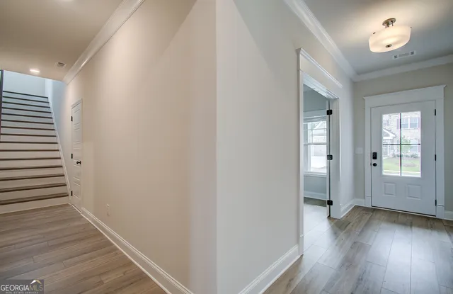 a view of a hallway with wooden floor