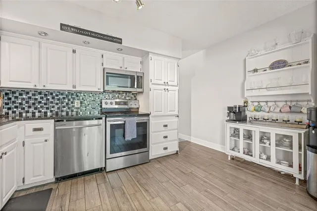 a kitchen with stainless steel appliances a stove and a refrigerator