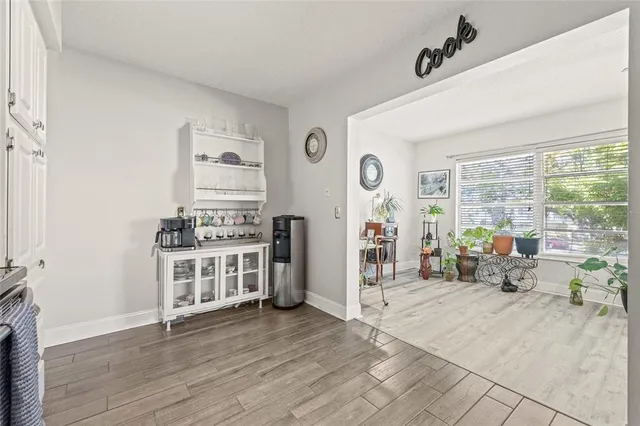 a kitchen with furniture and large window