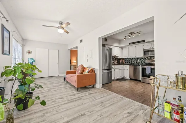 a living room with furniture and a kitchen view