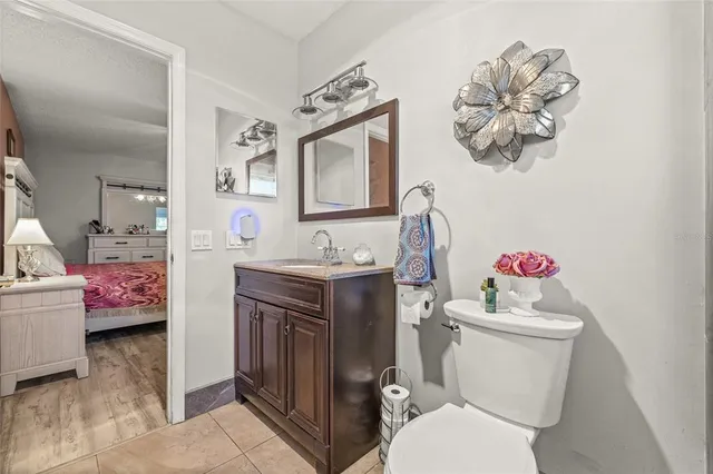 a bathroom with a sink vanity mirror and toilet