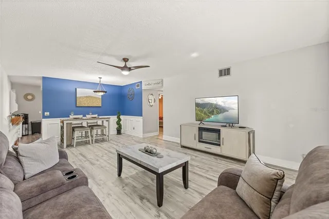 a living room with furniture and wooden floor