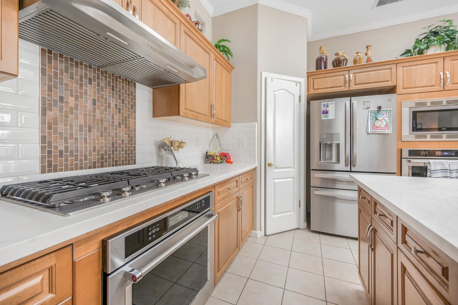 677 West Omaha Avenue Clovis, CA 93619 - Photo 11 of 35 a kitchen with stainless steel appliances granite countertop a stove and a refrigerator