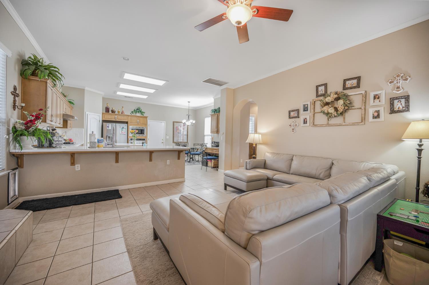 677 West Omaha Avenue Clovis, CA 93619 - Photo 14 of 35 a living room with furniture and a chandelier