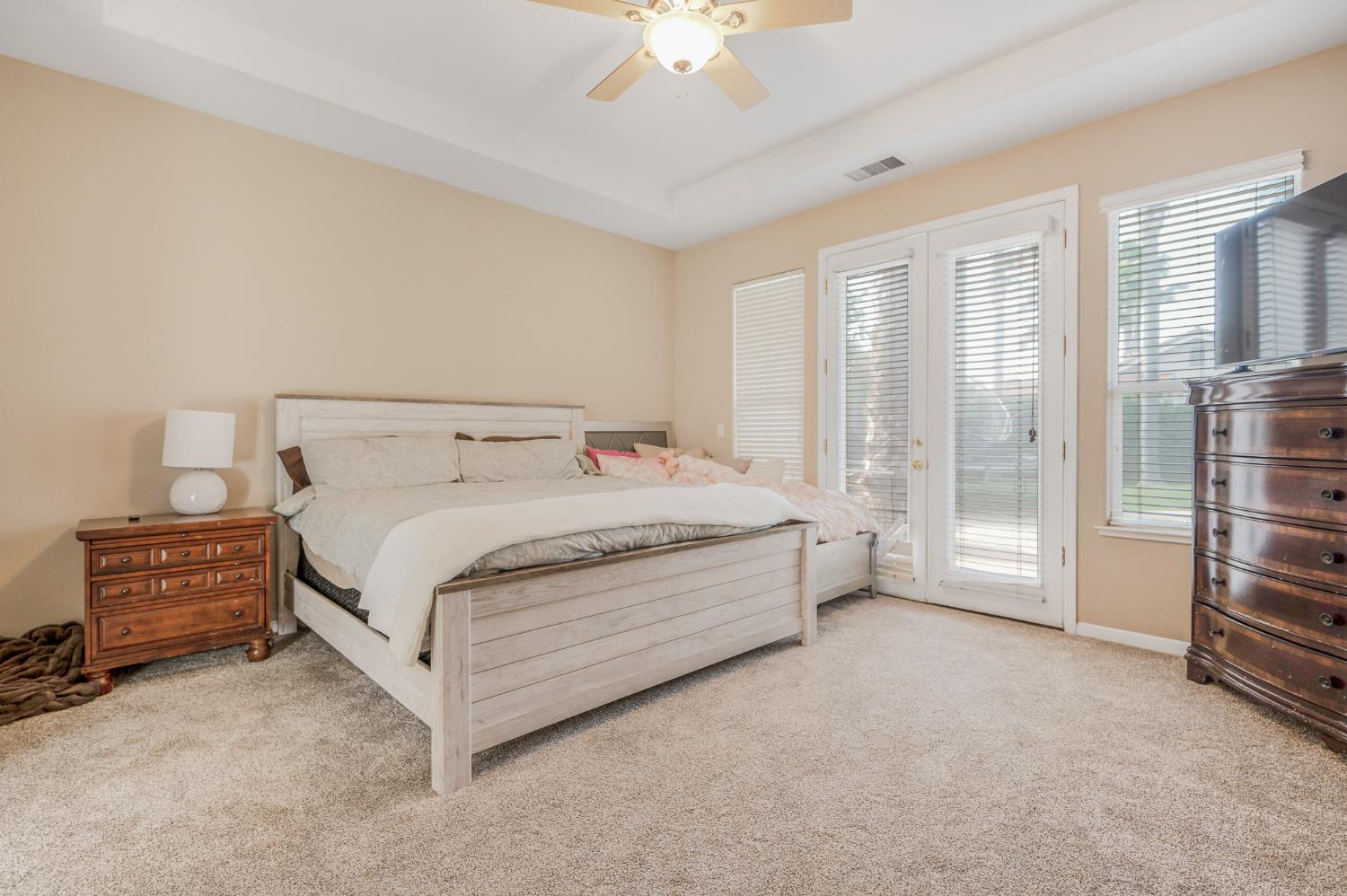 677 West Omaha Avenue Clovis, CA 93619 - Photo 18 of 35 a spacious bedroom with a bed and a chandelier