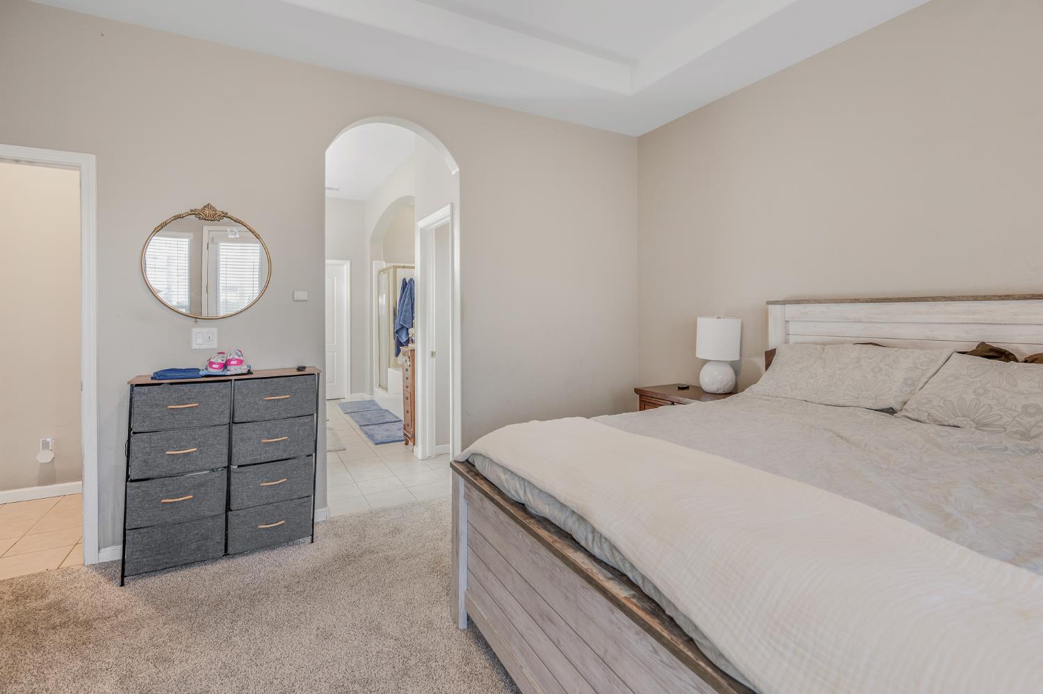 677 West Omaha Avenue Clovis, CA 93619 - Photo 19 of 35 a bedroom with a bed and a chandelier