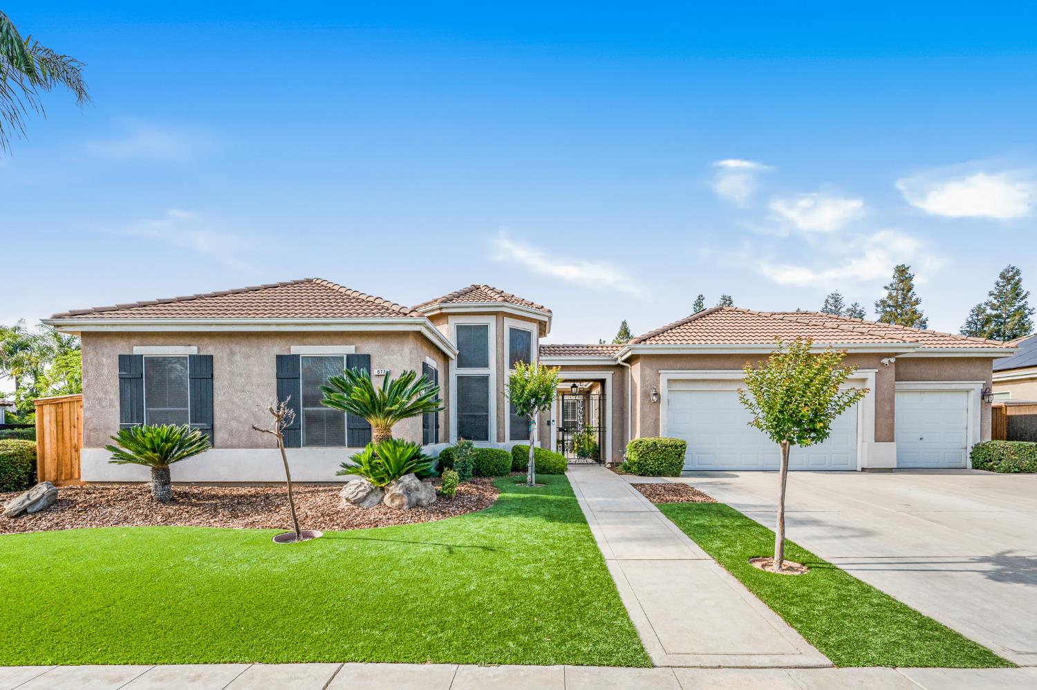 677 West Omaha Avenue Clovis, CA 93619 - Photo 35 of 35 a front view of a house with a yard and potted plants