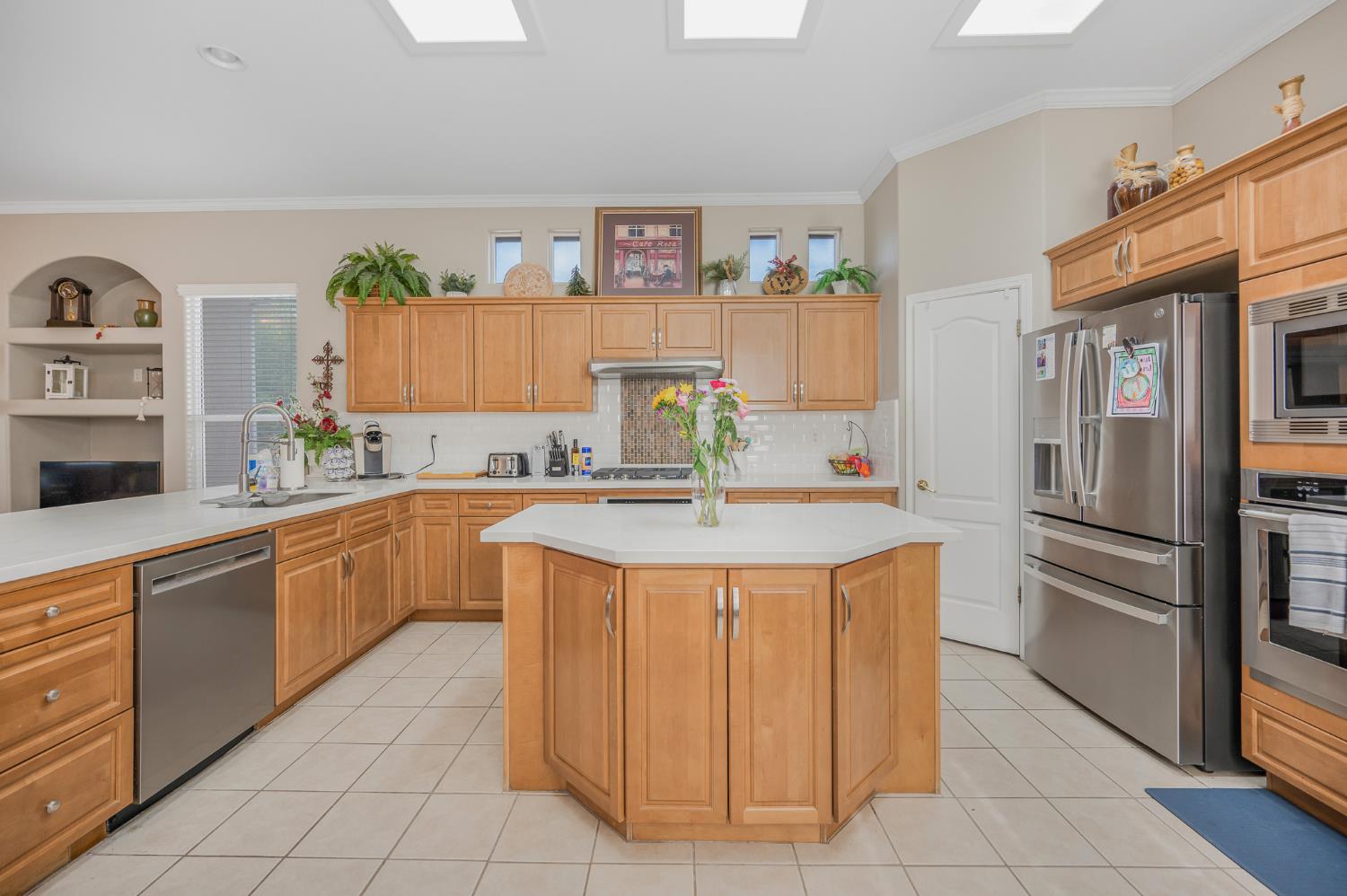 677 West Omaha Avenue Clovis, CA 93619 - Photo 7 of 35 a kitchen with stainless steel appliances granite countertop a refrigerator and a sink