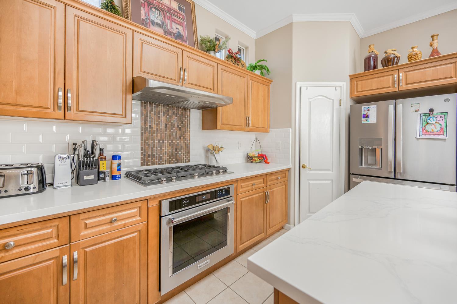 677 West Omaha Avenue Clovis, CA 93619 - Photo 10 of 35 a kitchen with stainless steel appliances granite countertop a stove a sink and a white cabinets