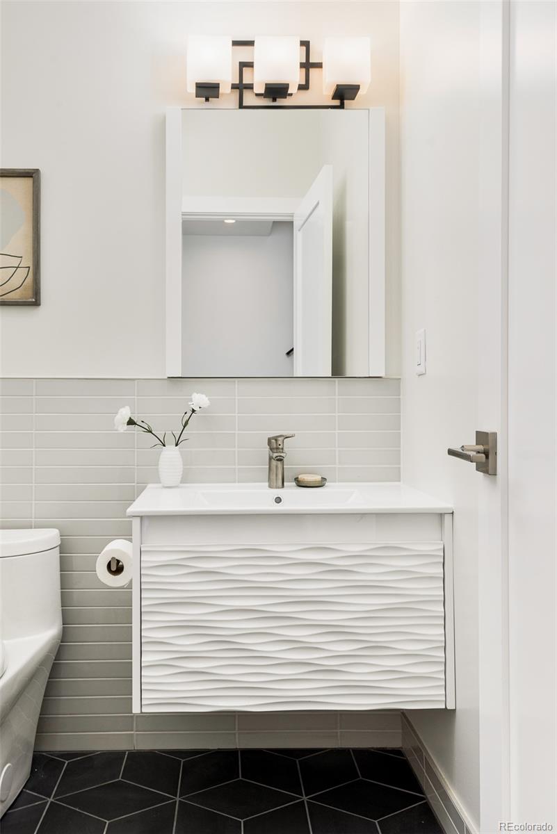 4461 Utica Street Denver, CO 80212 - Photo 11 of 40 a bathroom with a sink and a mirror