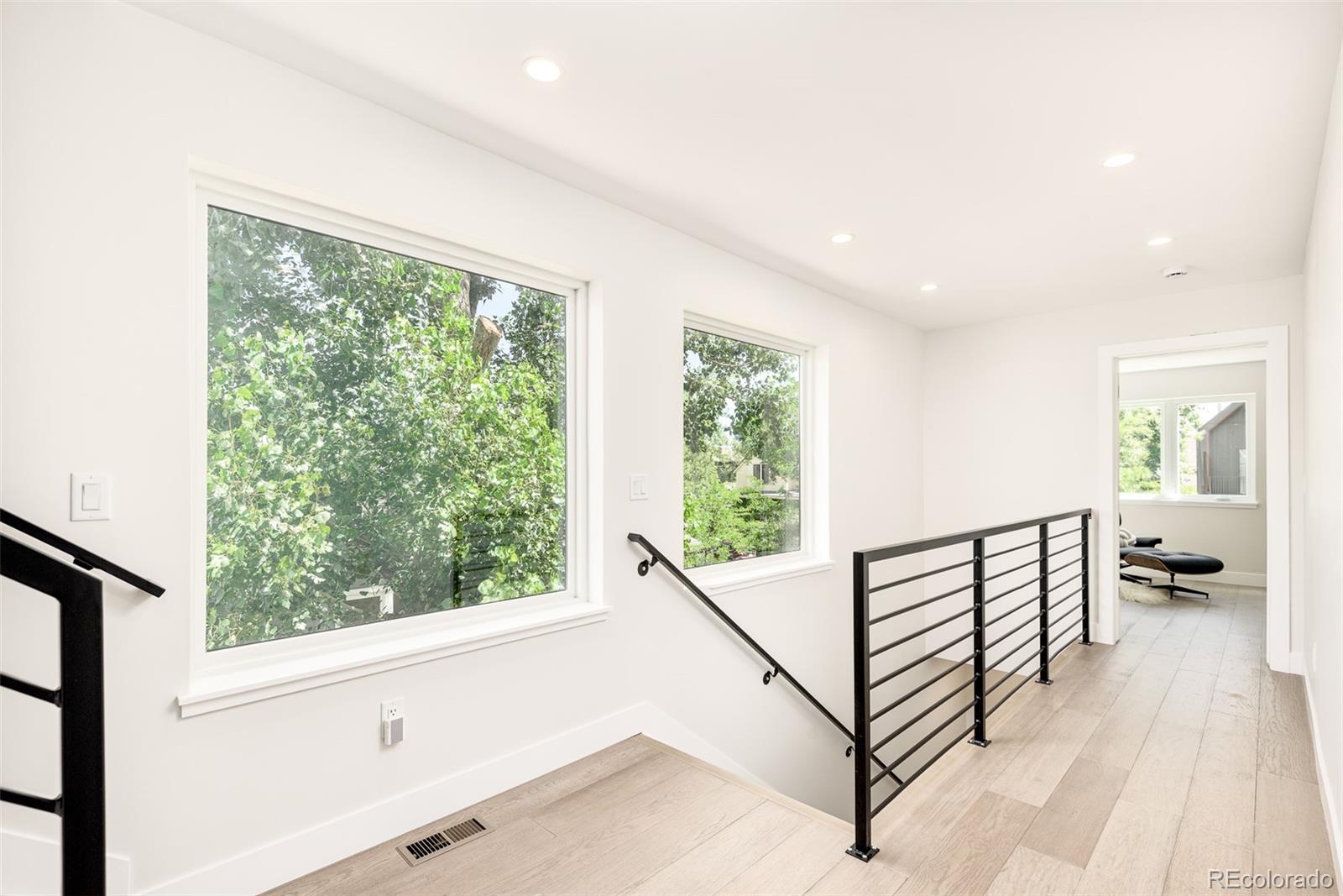 4461 Utica Street Denver, CO 80212 - Photo 15 of 40 a view of hallway with wooden floor and stairs
