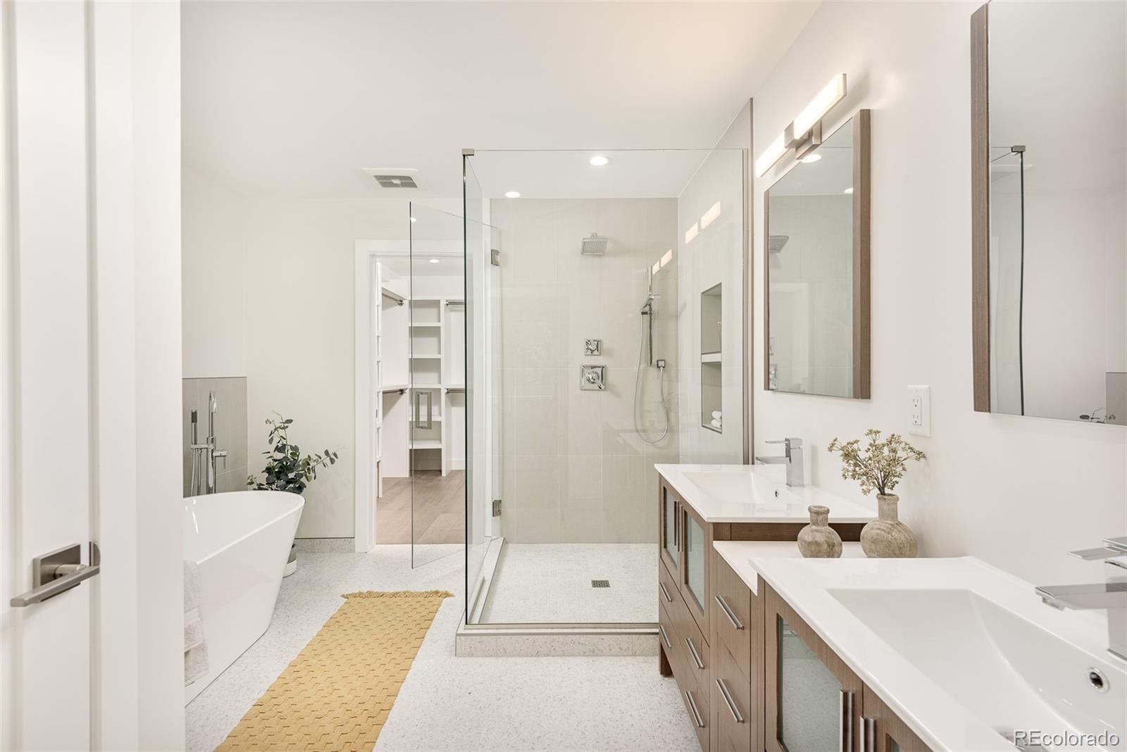 4461 Utica Street Denver, CO 80212 - Photo 18 of 40 a bathroom with a tub sink shower and mirror