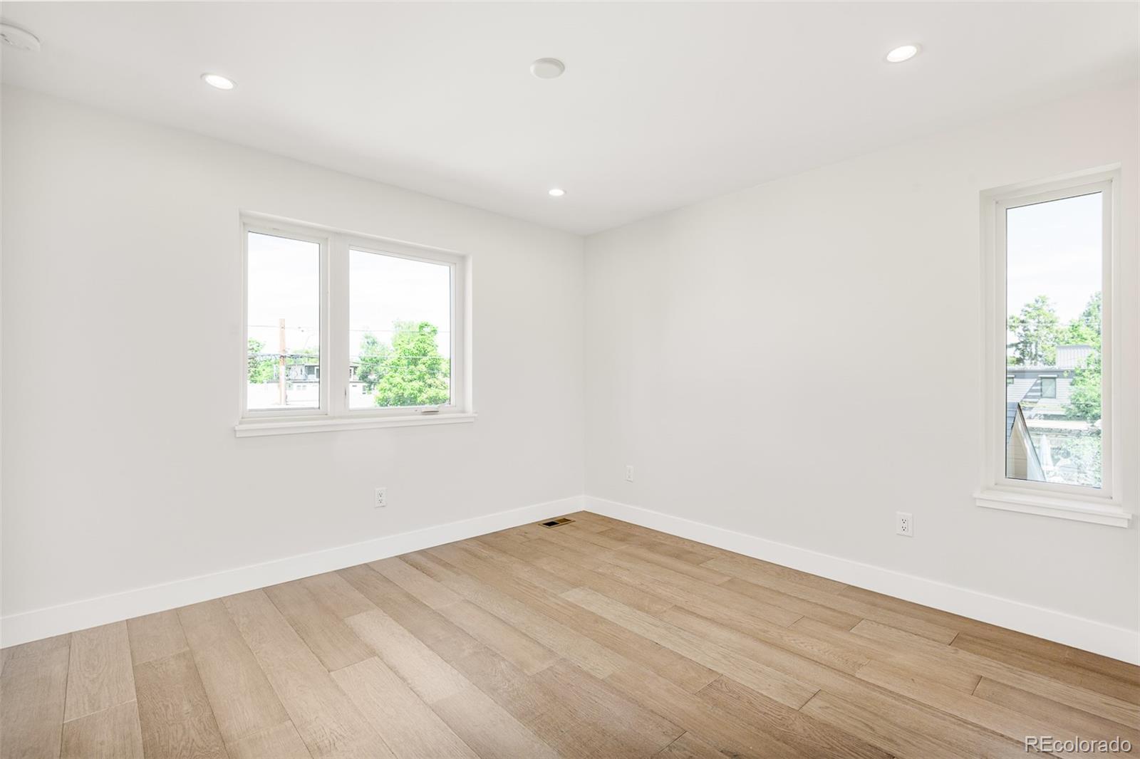 4461 Utica Street Denver, CO 80212 - Photo 24 of 40 an empty room with wooden floor and windows
