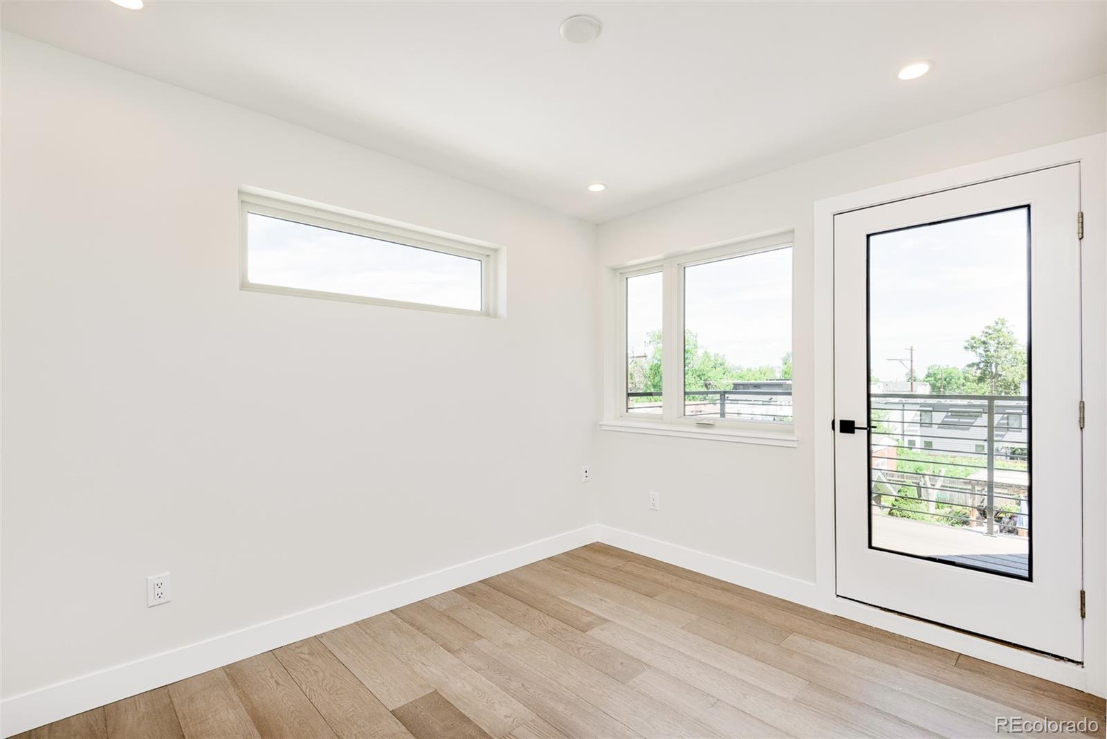 4461 Utica Street Denver, CO 80212 - Photo 26 of 40 an empty room with wooden floor and windows