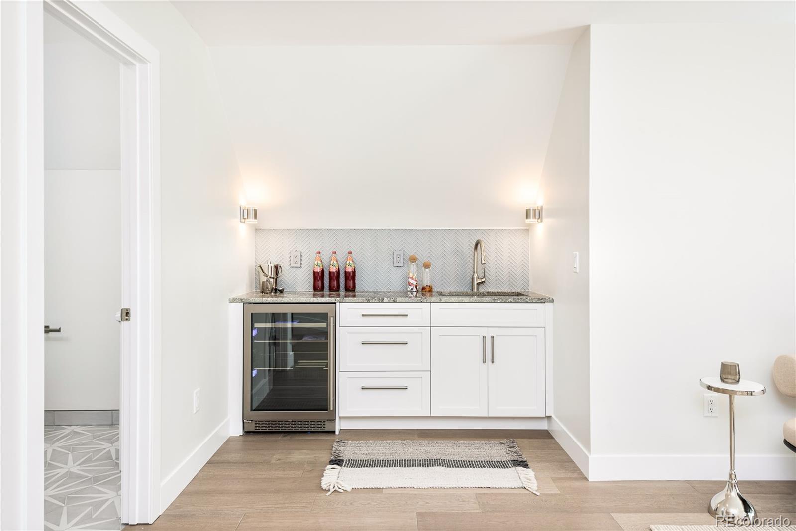 4461 Utica Street Denver, CO 80212 - Photo 28 of 40 a room with kitchen island cabinets and appliances