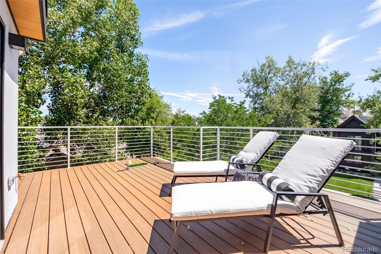4461 Utica Street Denver, CO 80212 - Photo 32 of 40 a view of deck with seating space and trees