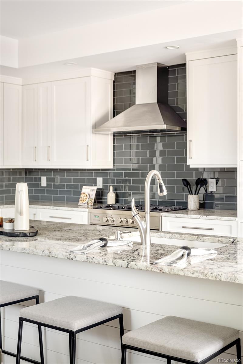 4461 Utica Street Denver, CO 80212 - Photo 5 of 40 a kitchen with a stove and a sink