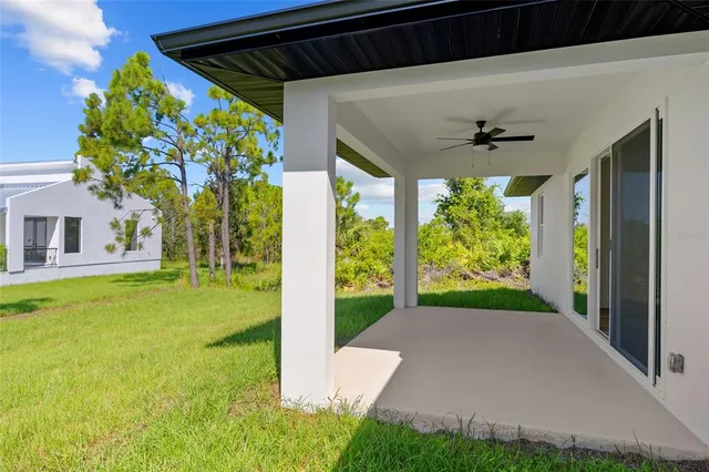 a view of a porch in front of a house with a big yard