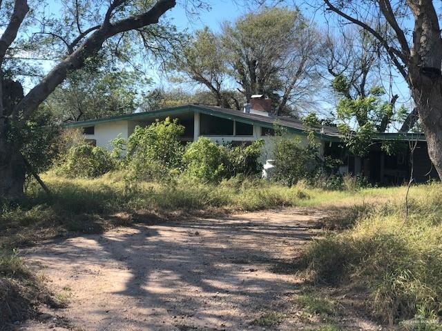 1800 Rio Rico Road Mercedes, TX 78570 - Photo 1 of 1 a front view of a house with a yard and shrubs