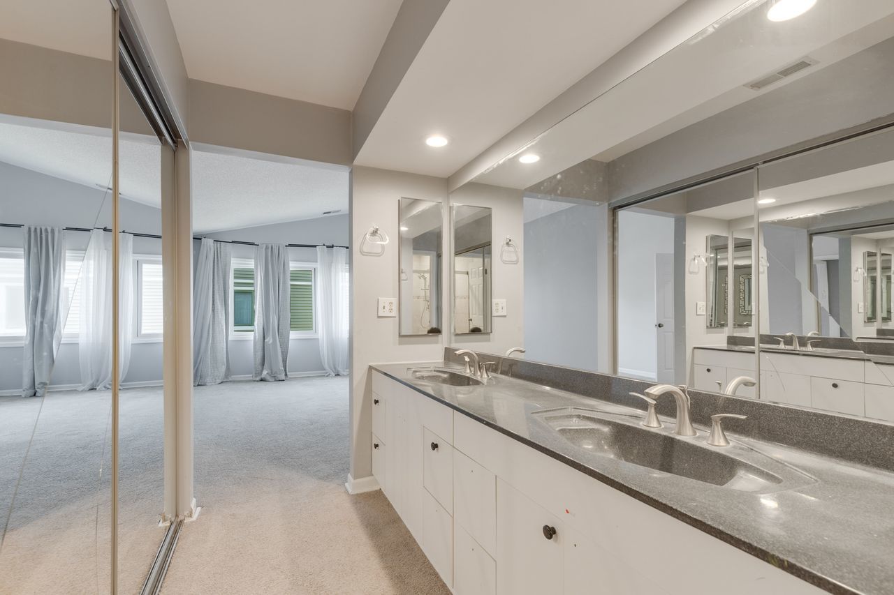 938 Hidden Lake Drive, Unit 938 Buffalo Grove, IL 60089 - Photo 12 of 16 a large bathroom with double vanity and a large mirror