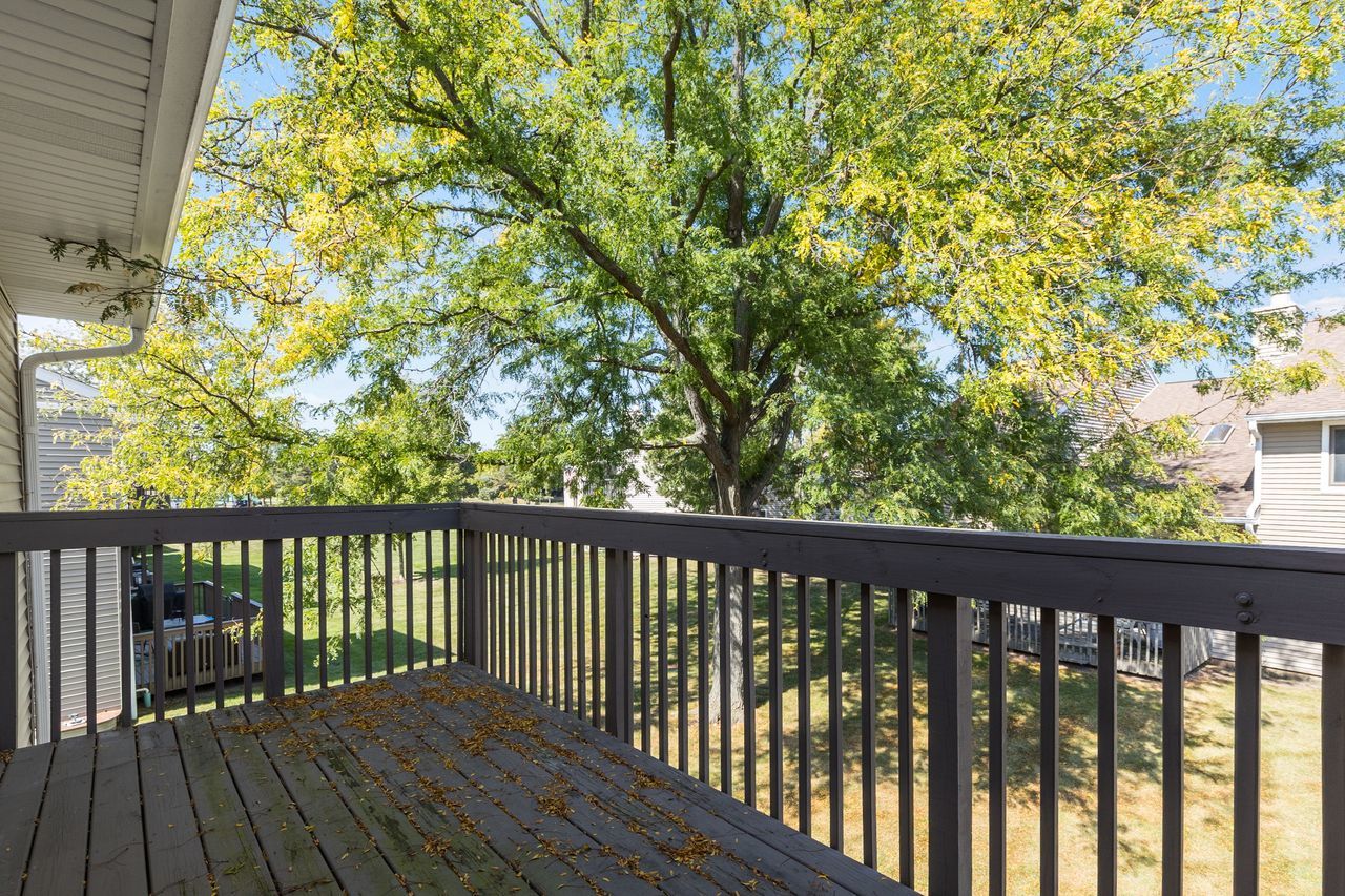 938 Hidden Lake Drive, Unit 938 Buffalo Grove, IL 60089 - Photo 14 of 16 a balcony with wooden floor and fence