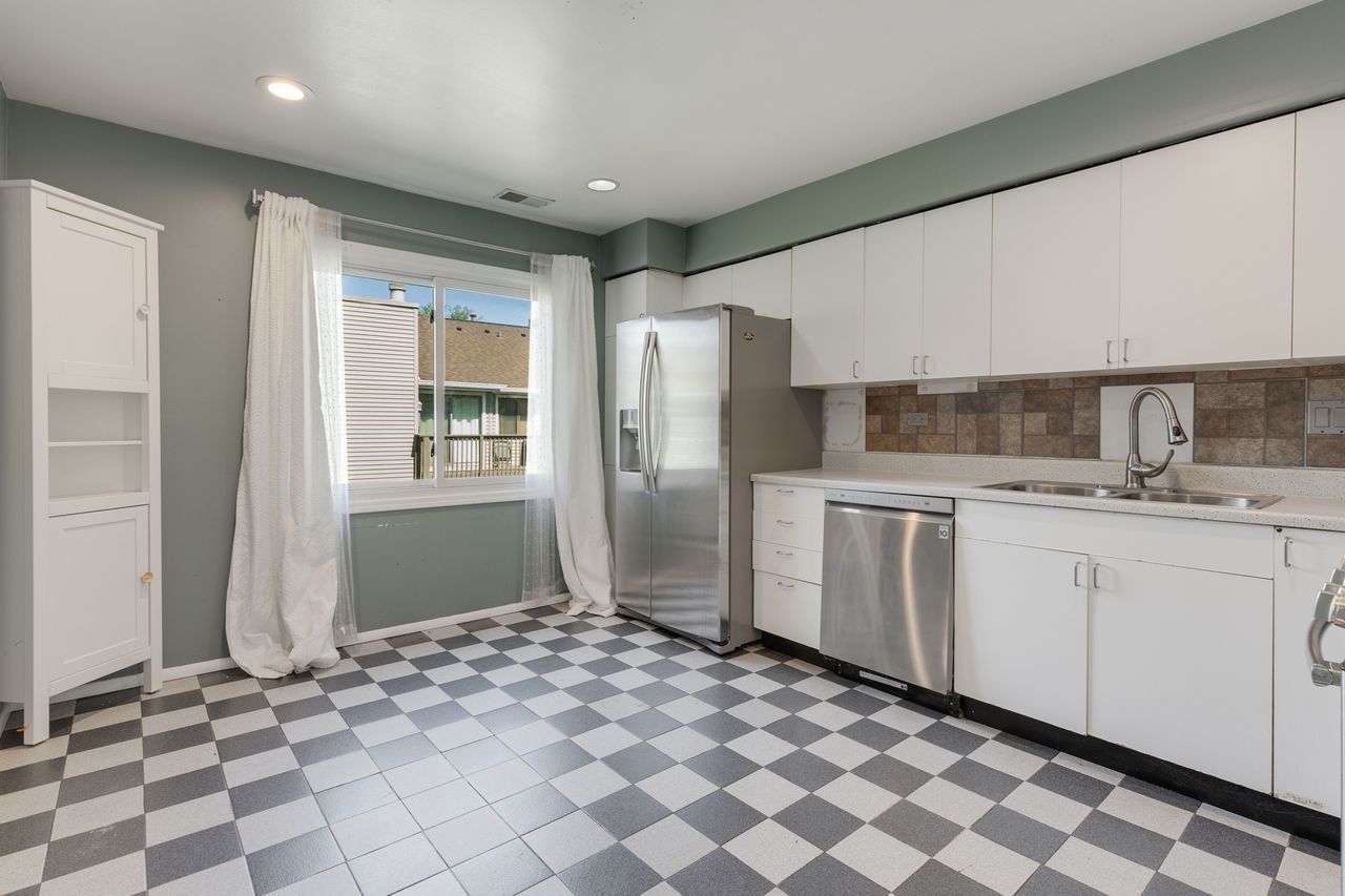 938 Hidden Lake Drive, Unit 938 Buffalo Grove, IL 60089 - Photo 7 of 16 a kitchen with stainless steel appliances granite countertop a refrigerator and a sink