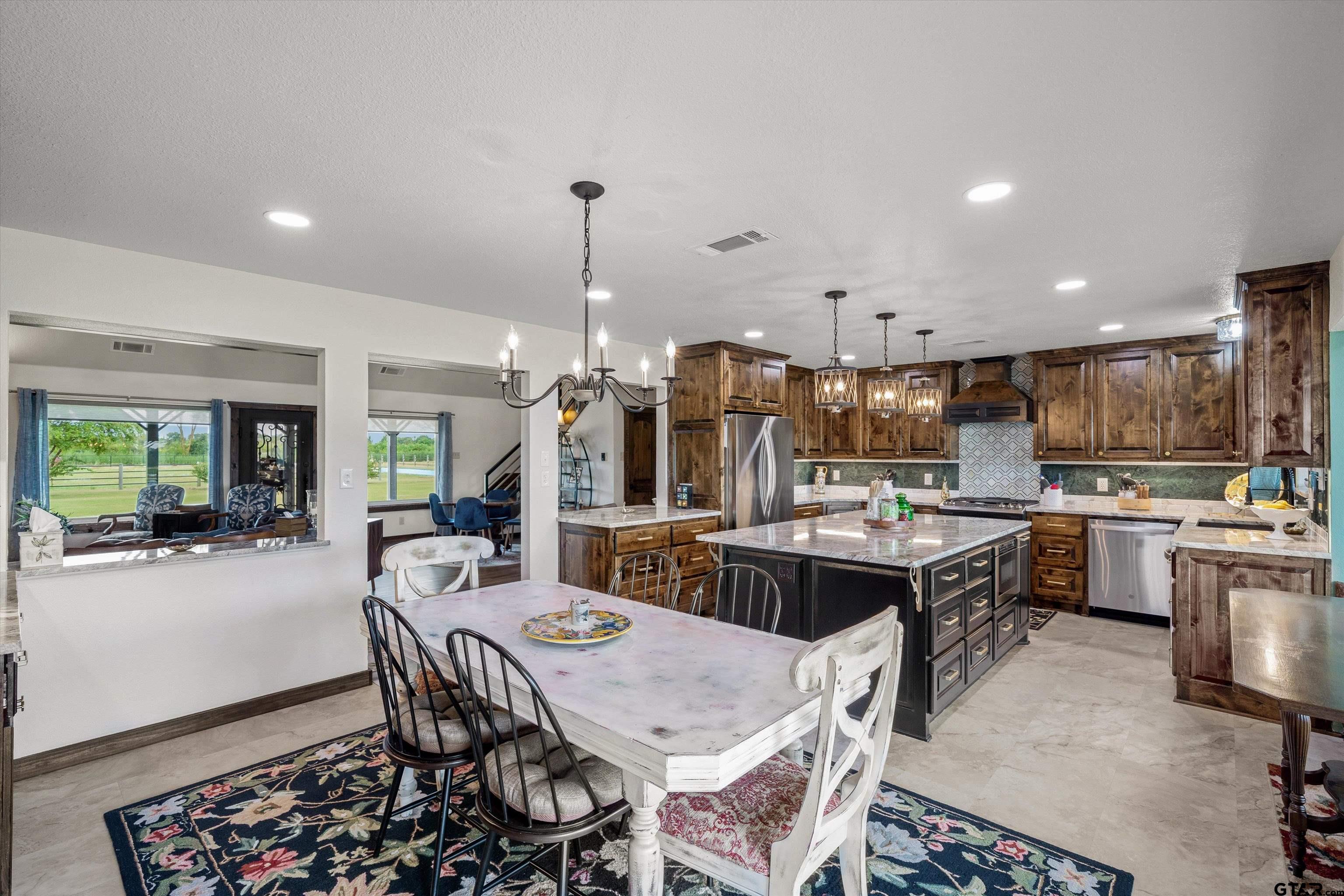 733 Rains County Road 1430 Point, TX 75472 - Photo 11 of 48 a large kitchen with a table and chairs