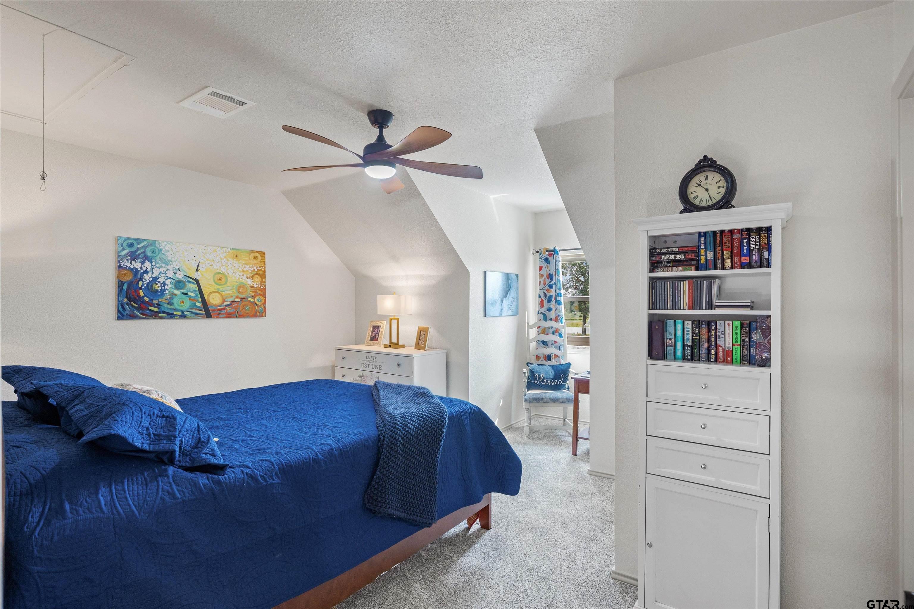 733 Rains County Road 1430 Point, TX 75472 - Photo 28 of 48 a bed room with a bed and a book shelf