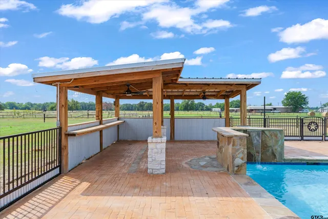 a view of a patio with a table and chairs under an umbrella with wooden floor