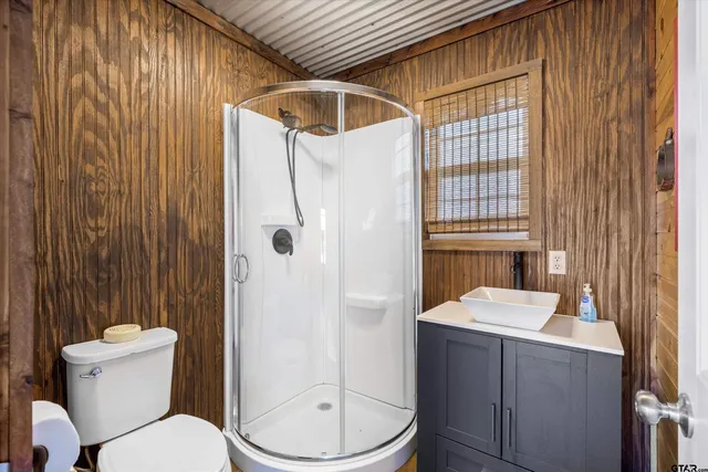 a bathroom with a toilet a sink and shower