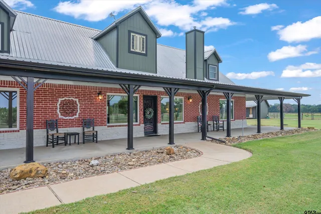 a view of a house with backyard porch and sitting area