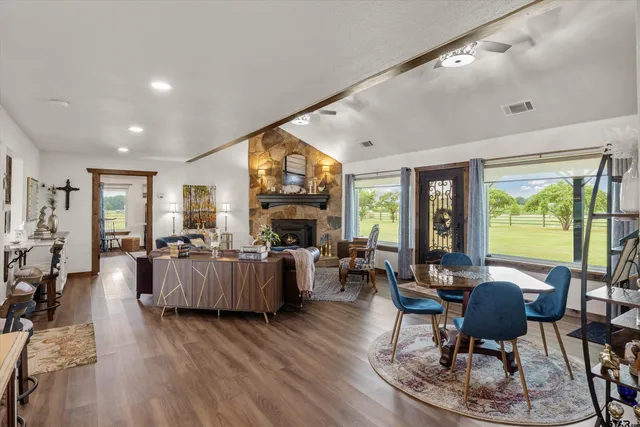 a living room with fireplace furniture and a large window
