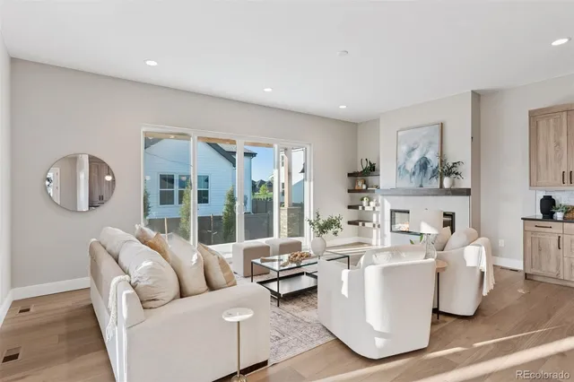 a living room with furniture and a wooden floor
