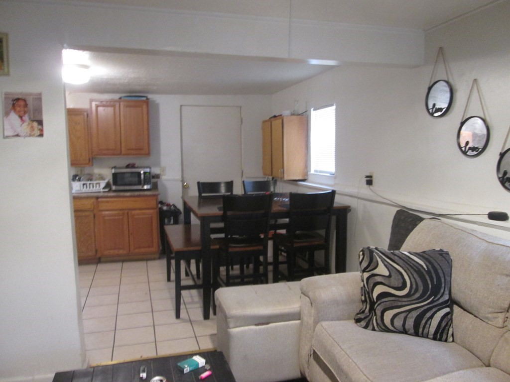 144 Cherry Street Springfield, MA 01105 - Photo 5 of 25 a living room with furniture a clock and a window