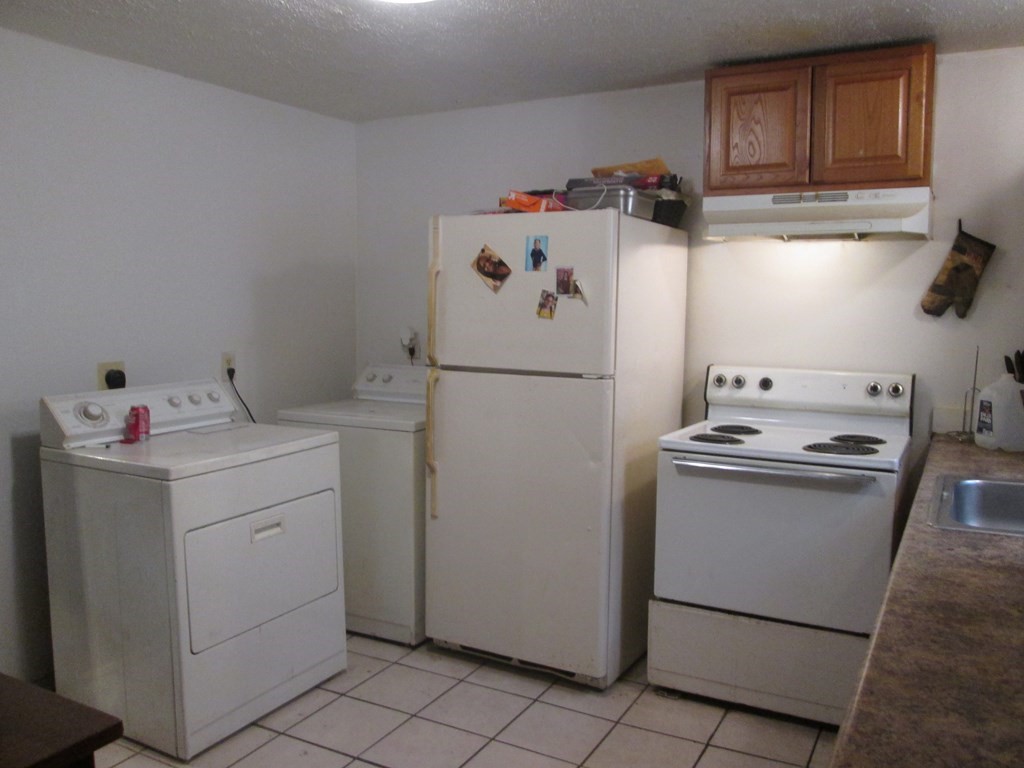 144 Cherry Street Springfield, MA 01105 - Photo 7 of 25 a utility room with cabinets washer and dryer