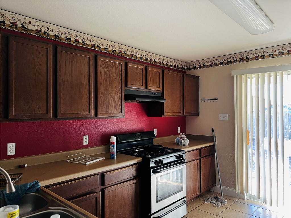 13024 Amaryllis Trail Elgin, TX 78621 - Photo 3 of 9 Kitchen with stand-along oven/range. No microwave. Dishwasher and disposal do not work, per sellers’ disclosure notice.