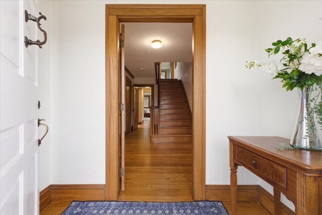 238 Harris Avenue Needham, MA 02492 - Photo 6 of 35 a view of a hallway with paintings on the wall