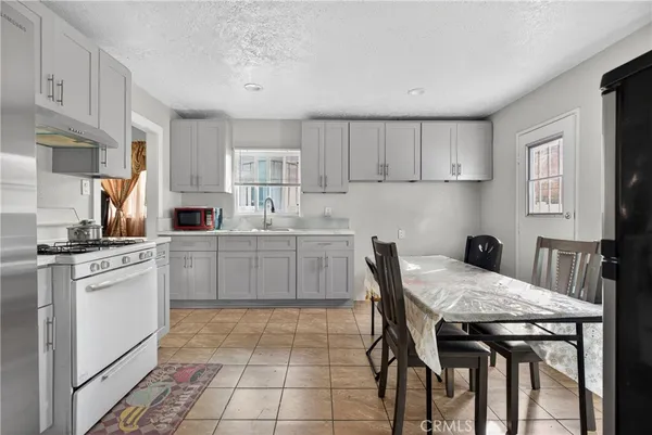 a kitchen with a stove a sink and a refrigerator
