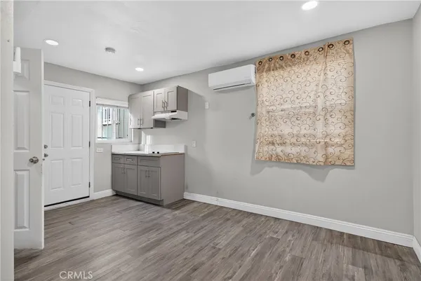 a room with a wooden floor and window