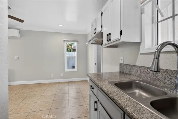 a kitchen with stainless steel appliances granite countertop a sink a stove and a granite counter tops