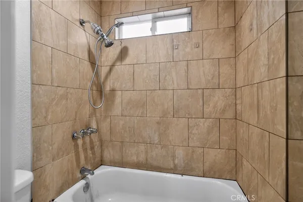 a bathroom with a bathtub and shower