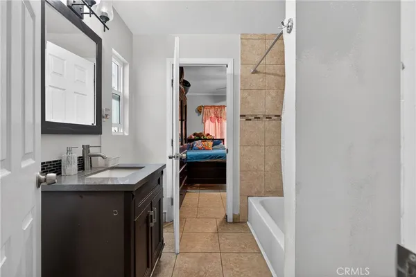 a en suite bathroom with a sink a vanity and a mirror