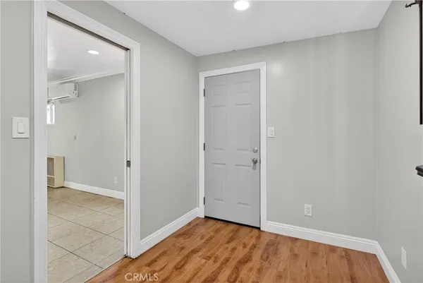 an empty room with wooden floor and closet