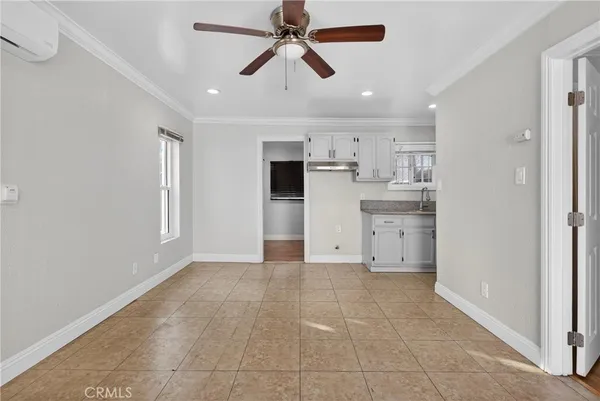 a view of a kitchen with a sink and dishwasher cabinets
