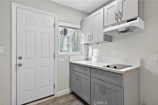 a kitchen with cabinets and window