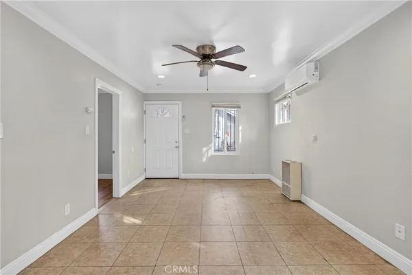 a view of a livingroom with a ceiling fan & window