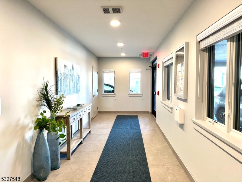 205 Stuyvesant Avenue, Unit 203 Lyndhurst, NJ 07071 - Photo 3 of 14 a lobby with furniture and potted plants