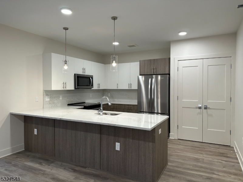 205 Stuyvesant Avenue, Unit 203 Lyndhurst, NJ 07071 - Photo 4 of 14 a kitchen with kitchen island a sink stainless steel appliances and refrigerator