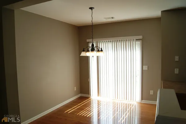 a view of a room with wooden floor