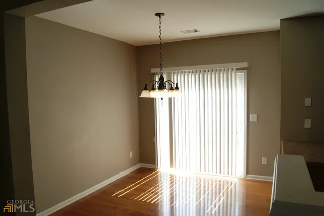 a view of a room with wooden floor